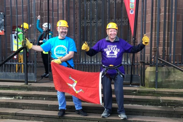 Paul Atkinson and Alan Cope holding the Manx flag