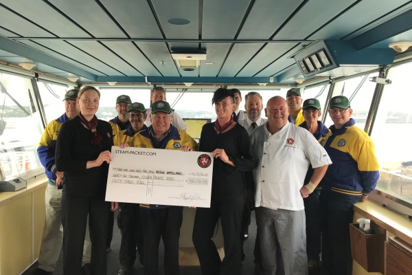 Isle of Man Steam Packet Company crew presenting Dr. David B. Stevens MBE, Director of the Rob Vine Fund and Hogg Motorsport crew with £22,011.53 on board Ben-my-Chree